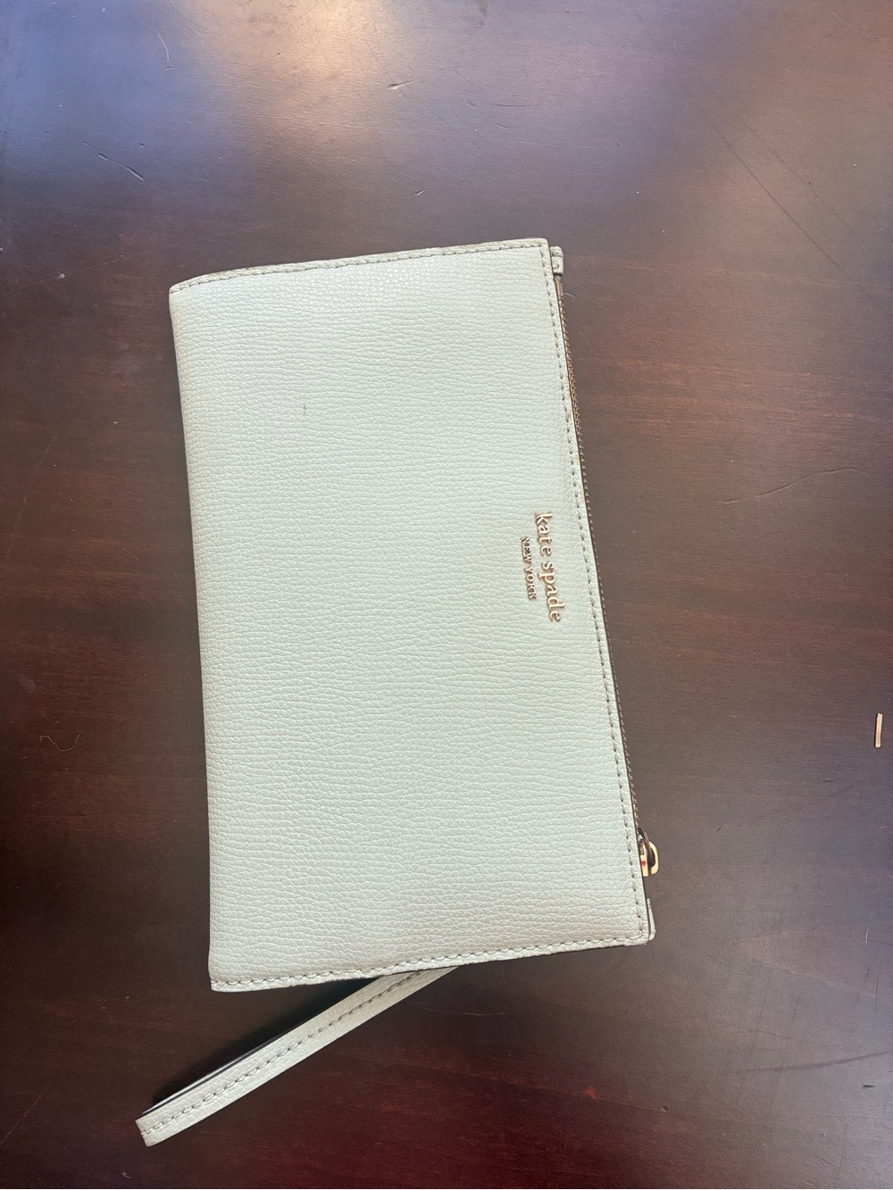 kate spade light cream leather wristlet clutch with gold logo